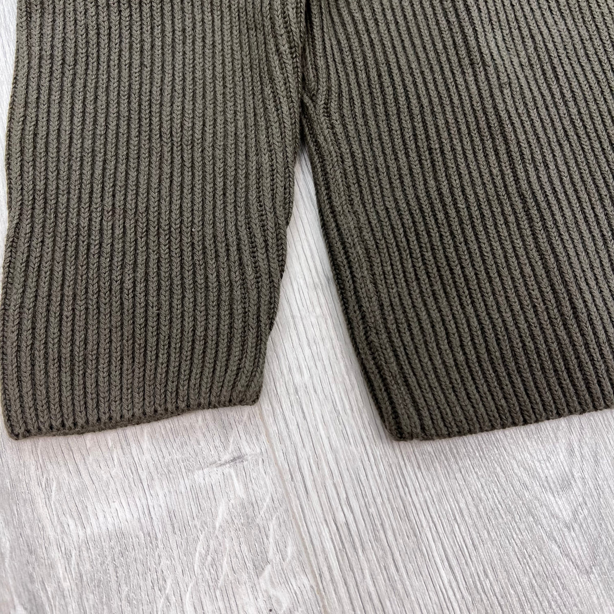 Close up view of the gauge 7 knit on a CP Company Full Rib Cotton Knit Sweatshirt in Ivy Green.