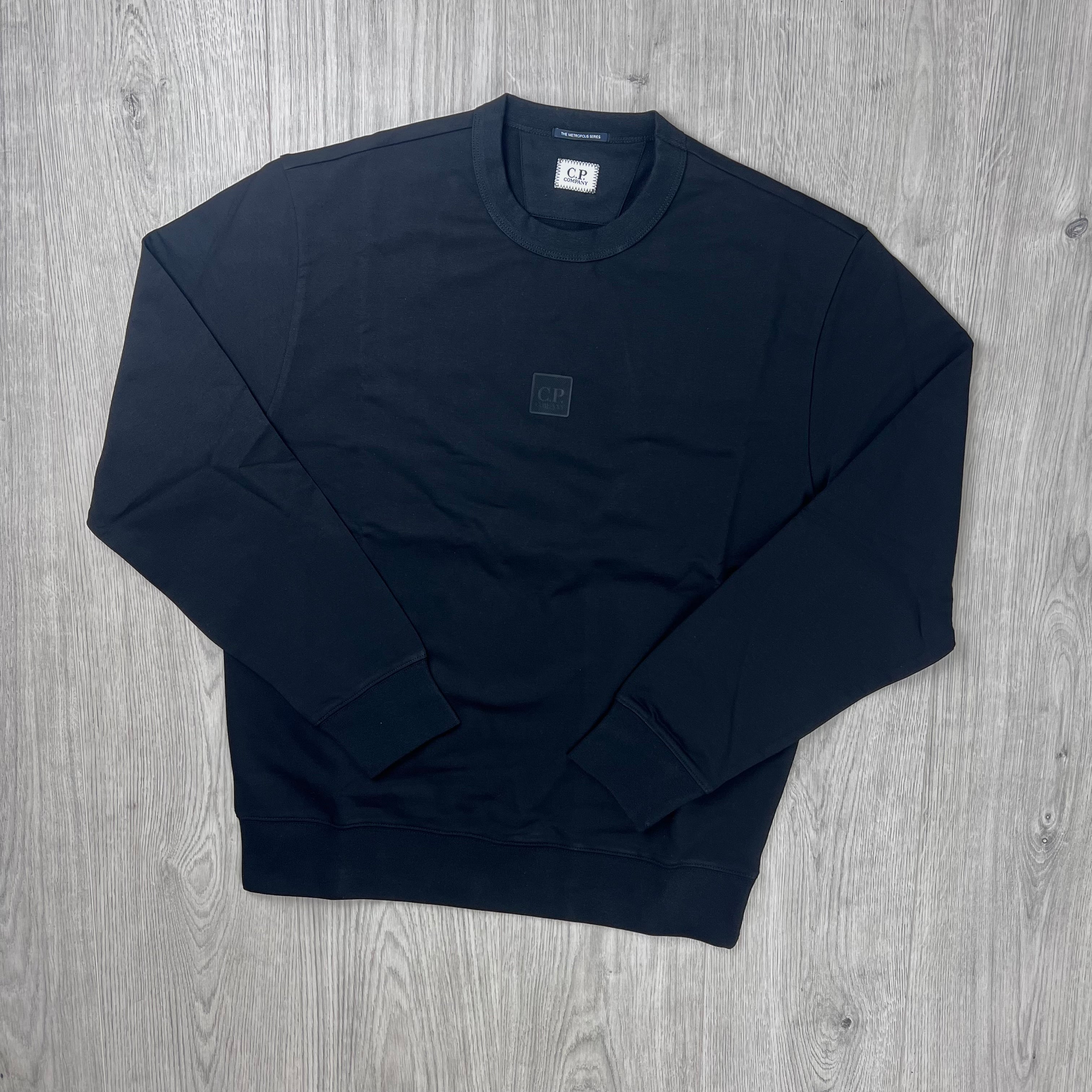 The front view of a CP Company Metropolis Series Stretch Fleece Sweatshirt with both arms folded.