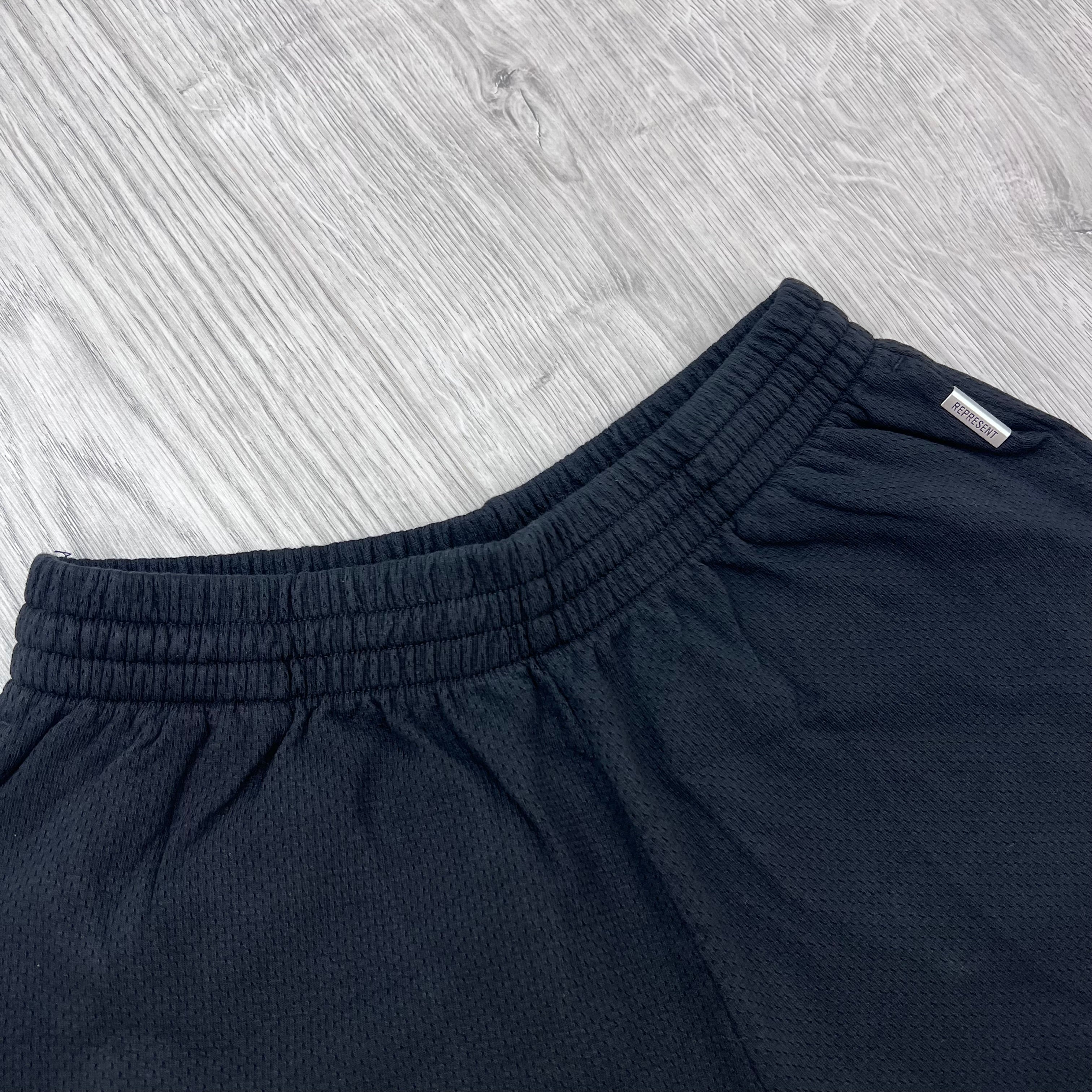 Front view of the elasticated waistband Represent Owners Club Mesh Shorts in Black.