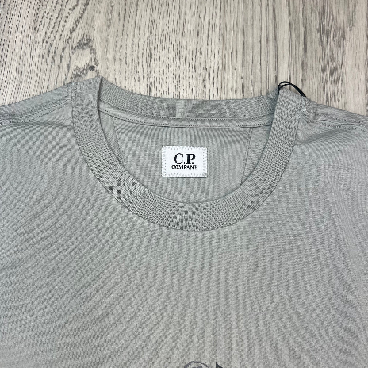 Close up view of the crewneck collar on a CP Company 30/1 Sailor T-Shirt in Silver Birch. 