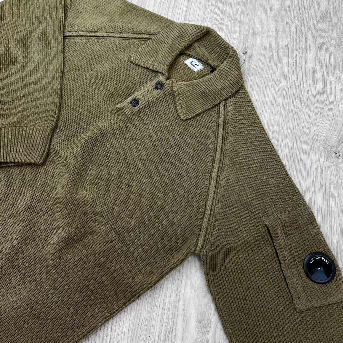 Angled view of the folded collar and lens on a CP Company Chenille Knit Polo Sweatshirt in Ermine.