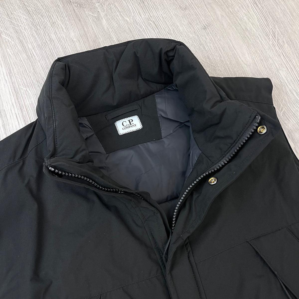 Close up view of the standing collar on a CP Company PrimaLoft Pro-Tek Gilet in Black.