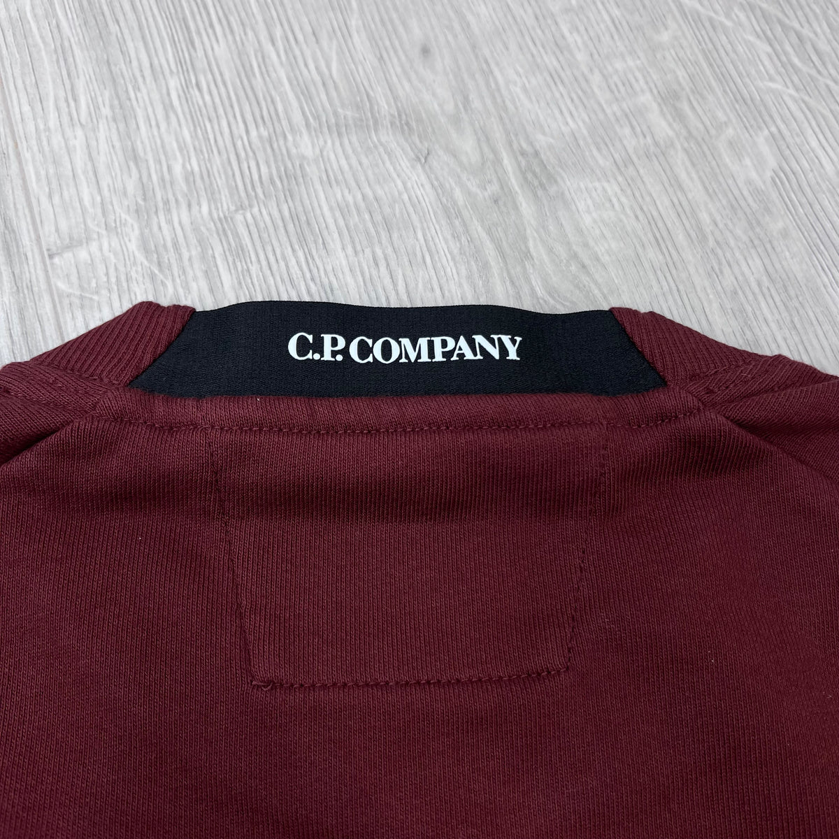 Close up view of the branded elasticated collar on a CP Company Raised Fleece Sweatshirt in Andorra. 