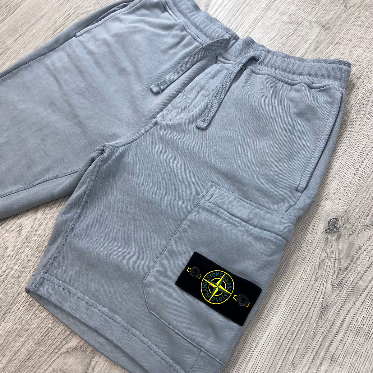 Angled view of the Stone Island Jersey Shorts in Ash Grey. 