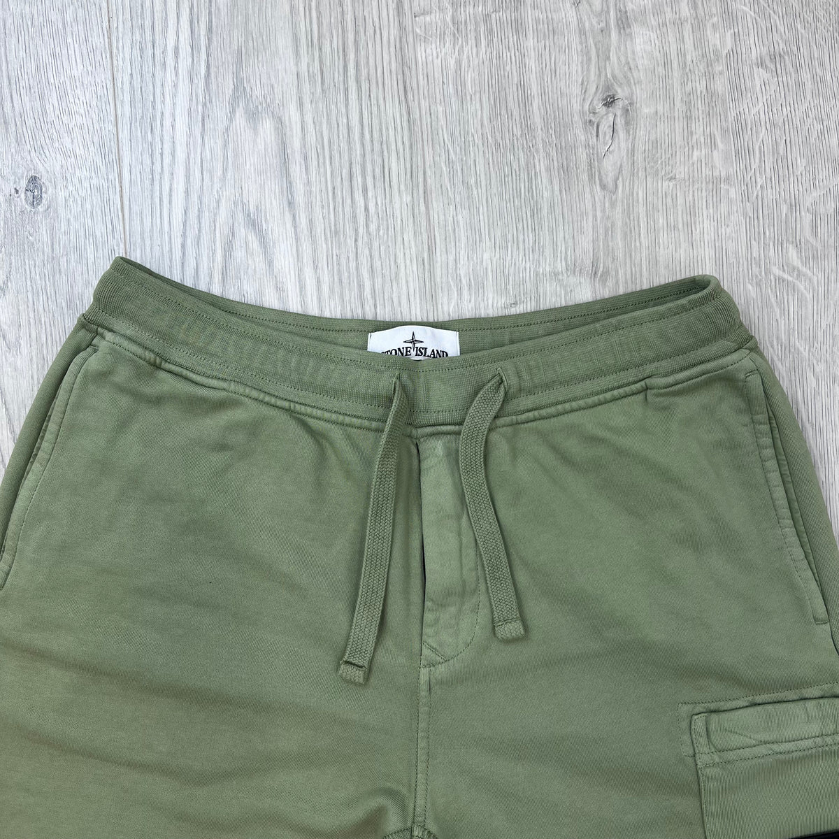 Front view of the waistband and drawstring on the Stone Island Jersey Shorts in Laurel Green. 