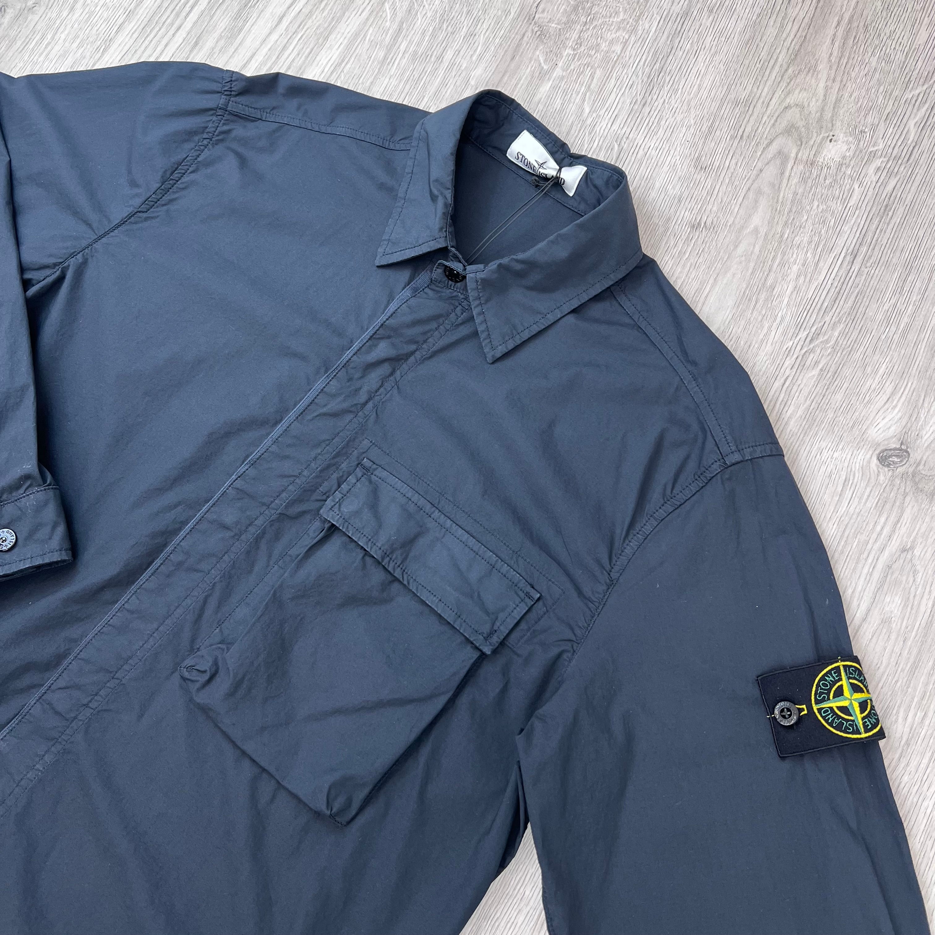 Top half of a Stone Island 'Paracadute' Overshirt in Navy Blue showing the badge.